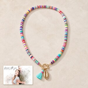Blue Fiesta Shell Necklace photographed in warm natural window light in an elegant home setting.