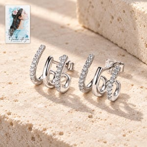 Triple Arc Stud Earrings, shown in natural light. A sample personalized digital greeting card is shown alongside.