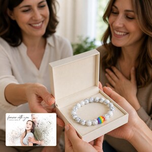 Spectrum bead Pride Bracelet Collection shown during a warm gift-receiving moment between adults with the exact jewelry visible.