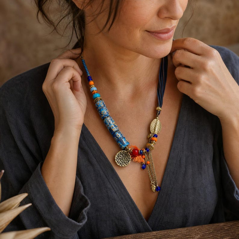 Three-piece handmade necklace set featuring beige and rose gold beaded necklace, rose gold and gray beaded necklace and rose gold and blue beaded necklace, displayed together to show the coordinated colors and beadwork