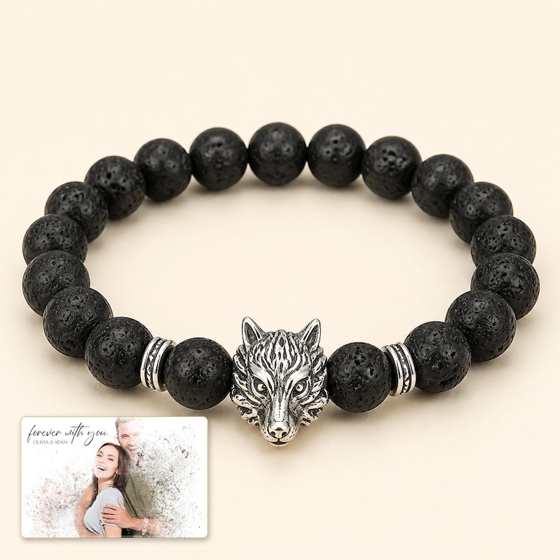 Black bead bracelet with silver-tone wolf-head detail, display view. A personalized greeting-card example appears in the corner.
