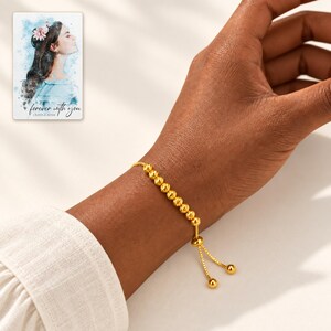 Golden Spiral Bead Slider Bracelet worn by an adult model for styling and everyday styling. A personalized digital greeting card is shown alongside.