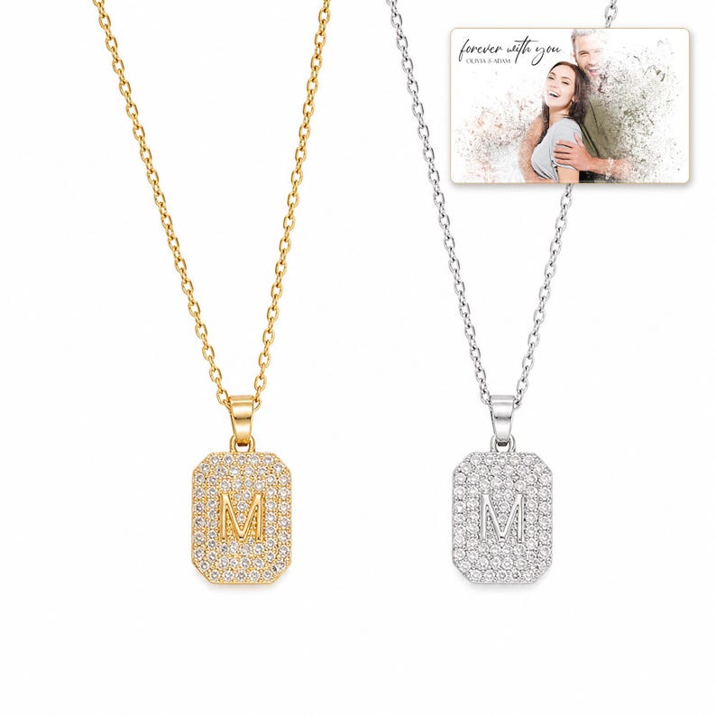Mosaic Initial M Necklace Duo shown during a believable gift-giving moment between adults with the exact jewelry visible.