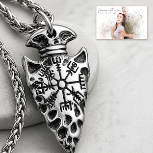 Aegis North Nordic Arrowhead Necklace shown during a warm gift-receiving moment between adults with the exact jewelry visible.