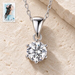 Moissanite Pendant Necklace, shown on a display surface. A sample personalized digital greeting card is shown alongside.