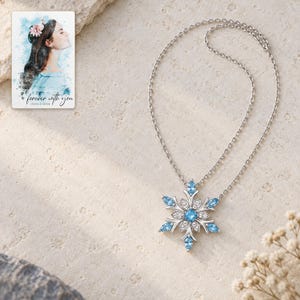 Winter Azure Snowflake Necklace shown as the main Etsy hero photograph with a clear view of the complete design. A personalized digital greeting card is shown alongside.