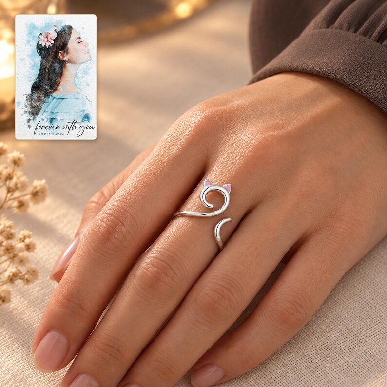 Adult woman wearing the open cat-curl ring with a taupe blouse in an evening setting. A personalized digital greeting card is shown alongside.