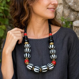 Three-piece handmade necklace set featuring brown and silver beaded necklace, silver and gray beaded necklace and brown and bronze beaded necklace, displayed together to show the coordinated colors and beadwork