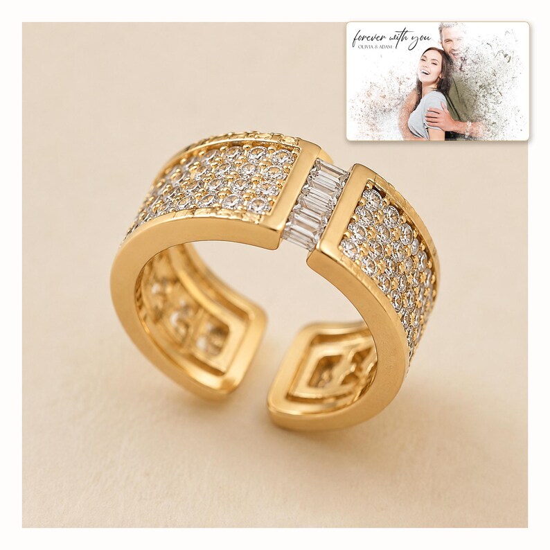 Gold-tone open ring with rows of clear accents, catalog view. A personalized greeting-card example appears in the corner.