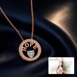 Adult woman wearing the Rose Gold HOPE heart necklace in a natural daytime lifestyle scene.