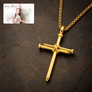 Forged Faith Nail Cross Necklace photographed in warm natural window light in an elegant home setting.