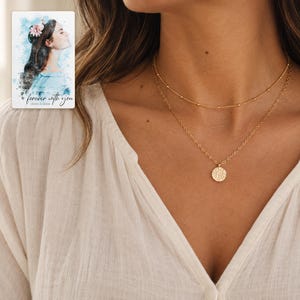 Gold Tone Coin Satellite Necklace worn by an adult model for styling and everyday styling. A personalized digital greeting card is shown alongside.