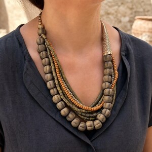 Three-piece handmade necklace set featuring rose gold and beige beaded necklace, rose gold and bronze beaded necklace and rose gold and brown beaded necklace, displayed together to show the coordinated colors and beadwork