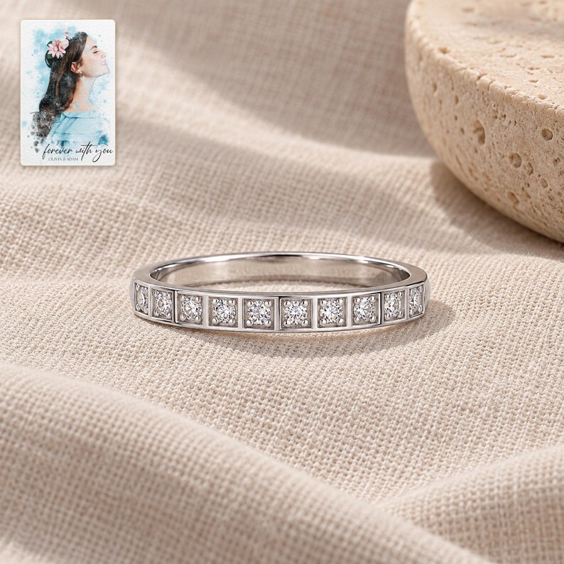 Moissanite Band Ring, laid on fabric. A sample personalized digital greeting card is shown alongside.