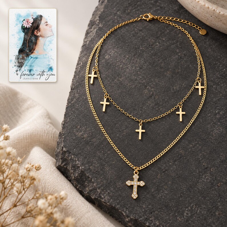 Golden Faith Layered Cross Necklace styled against a dark luxury surface with the exact product finish clearly visible. A personalized digital greeting card is shown alongside.