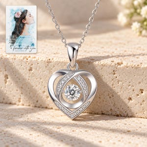 Moissanite Heart Necklace, sunlit home view. A personalized digital greeting card is shown alongside.