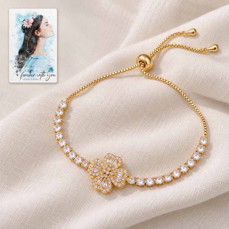 Golden Petal Slider Bracelet arranged on soft ivory linen in a refined neutral flat lay. A personalized digital greeting card is shown alongside.
