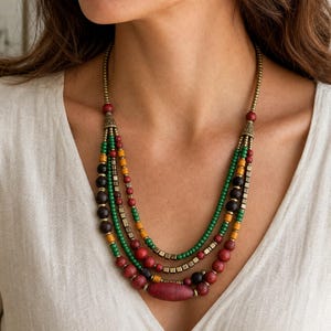 Rose Gold and Silver Statement Beaded Necklace presented in an open jewelry gift box on natural linen