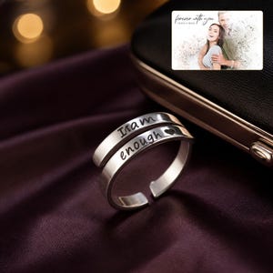 Brave Word Open Band Ring arranged on soft ivory linen in a refined neutral flat lay.