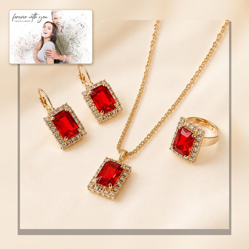 Red rectangular-stone necklace, matching earrings and ring, framed product view. A personalized greeting-card example appears in the corner.