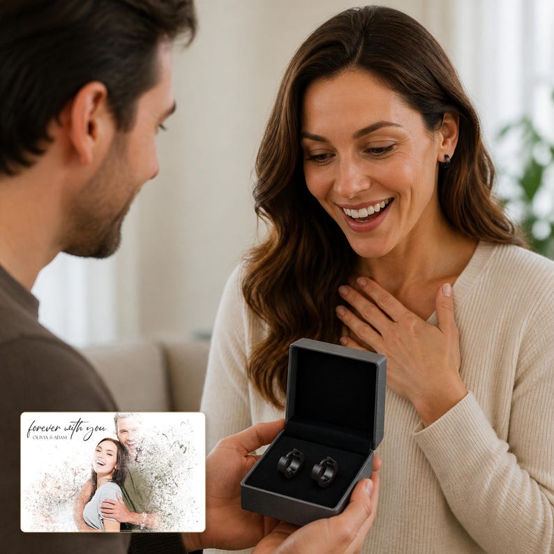 May include: A pair of matte black hoop earrings presented in a dark gray square jewelry box. A rectangular card is included, featuring a printed photograph of a couple with the cursive text "forever with you" and the names "OLIVIA & ADAM" below it.
