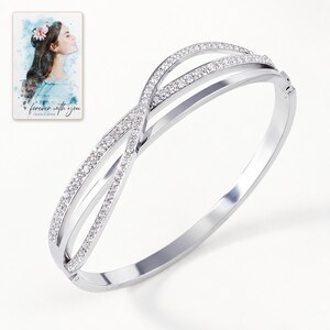 Crossover Bangle Bracelet, shown against a light background. A sample personalized digital greeting card is shown alongside.