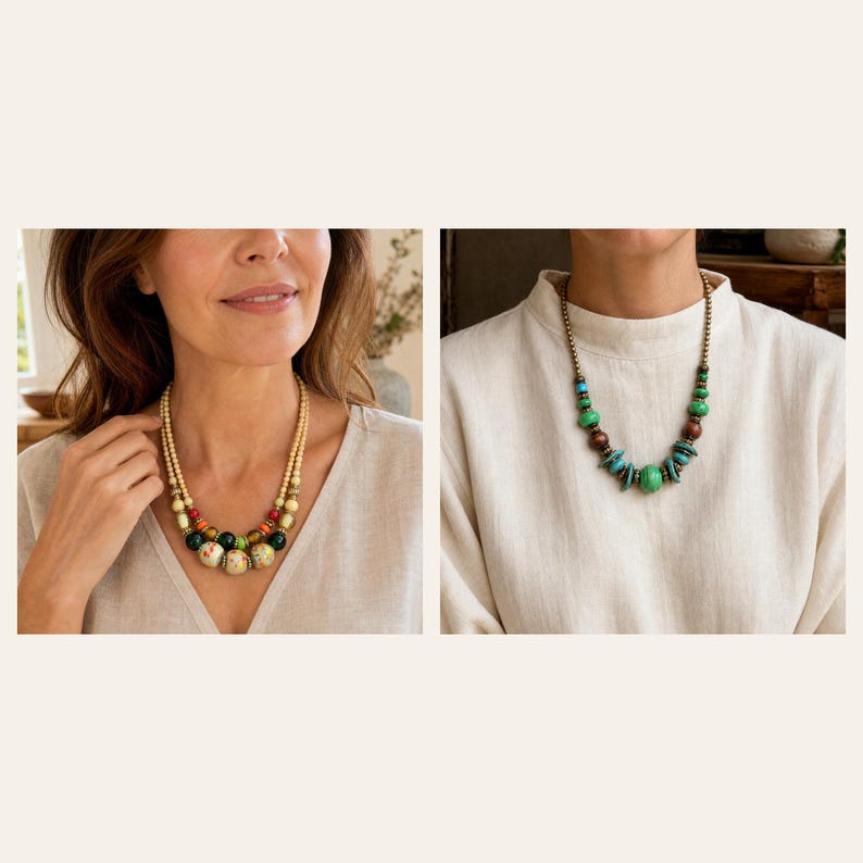 May include: A two-strand necklace featuring cream-coloured beads, red, green, and floral-patterned accents, alongside a single-strand necklace with green, brown, and turquoise-coloured beads on a metallic chain, both worn over a light-coloured top.