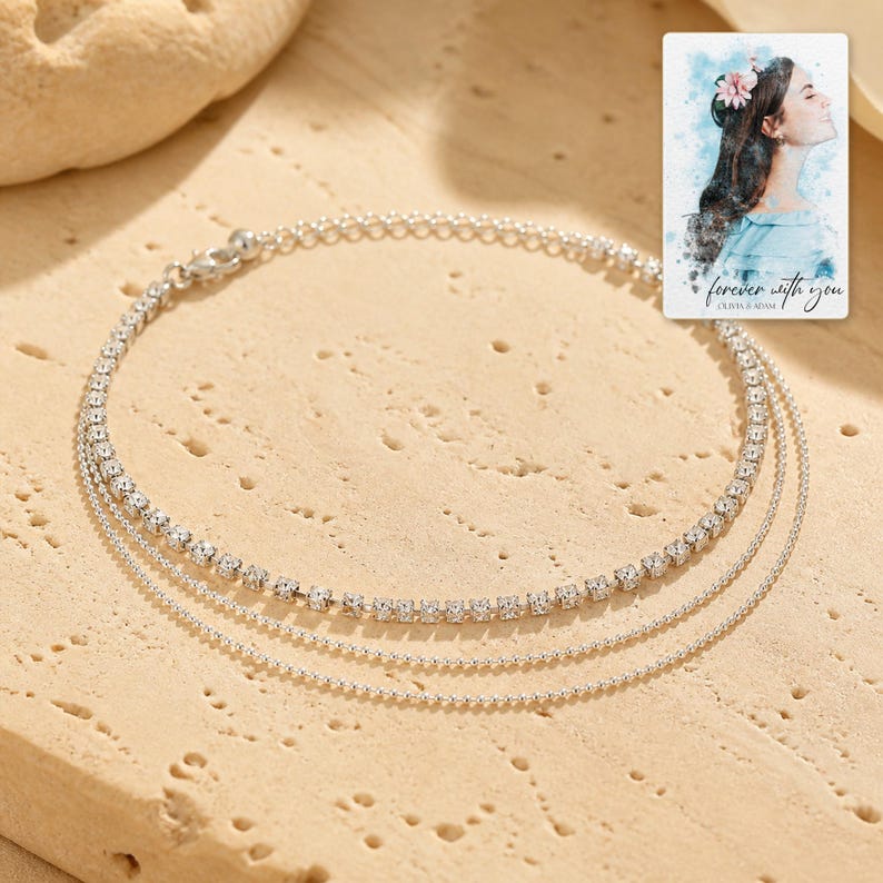 Silver Starlight Layered Anklet photographed in warm natural window light in an elegant home setting.