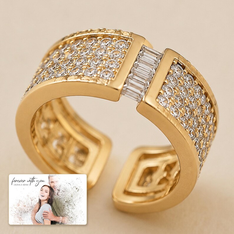 Gold-tone open ring with rows of clear accents, close detail view. A personalized greeting-card example appears in the corner.