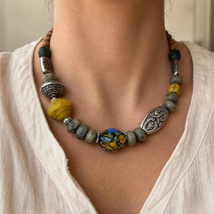 Rose Gold and Silver Statement Beaded Necklace presented in an open jewelry gift box on natural linen