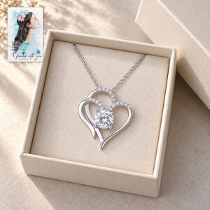 Double Heart Pendant Necklace, displayed in a presentation box. A sample personalized digital greeting card is shown alongside.