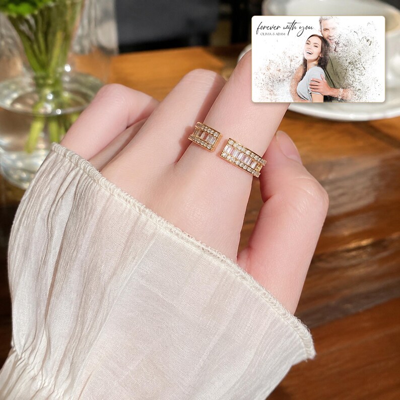 Gold-tone open ring with rows of clear accents, adult lifestyle view. A personalized greeting-card example appears in the corner.