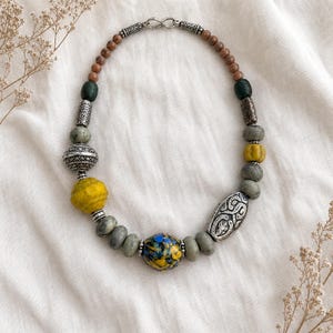 Rose Gold and Silver Statement Beaded Necklace presented in an open jewelry gift box on natural linen