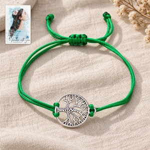 Tree of Life Cord Bracelet, laid on fabric. A sample personalized digital greeting card is shown alongside.