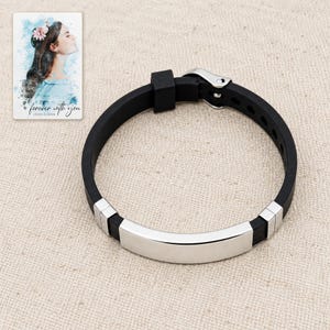 Black adjustable strap bracelet with a plain curved bar arranged on oatmeal linen. A personalized digital greeting card is shown alongside.