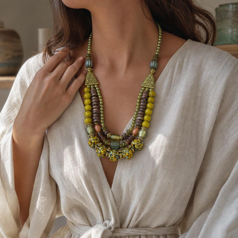 Brown and Bronze Statement Beaded Necklace displayed on a jewelry bust, showing the necklace shape and artisan bead details