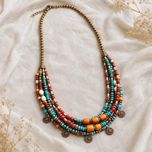 Beige and Brown Statement Beaded Necklace presented in an open jewelry gift box on natural linen