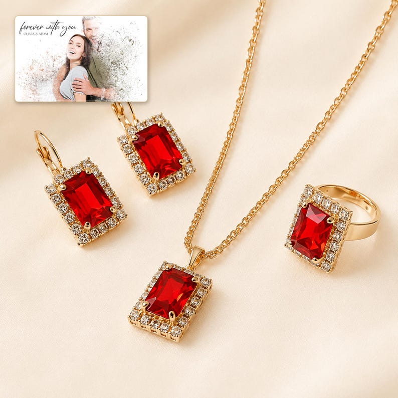 Red rectangular-stone necklace, matching earrings and ring, display view. A personalized greeting-card example appears in the corner.