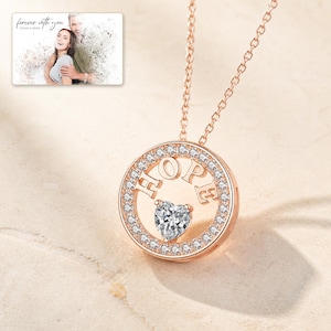 Rose Gold HOPE necklace with a heart-cut cubic zirconia center styled as an elegant jewelry hero image.