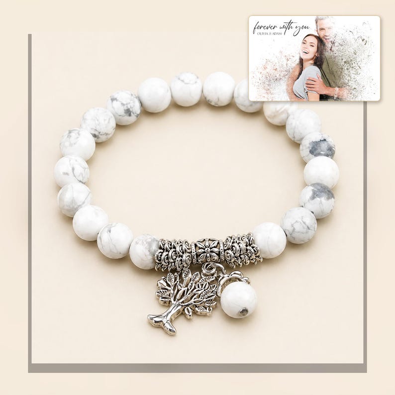 White and gray bead bracelet with silver-tone tree and hanging bead details, framed product view. A personalized greeting-card example appears in the corner.