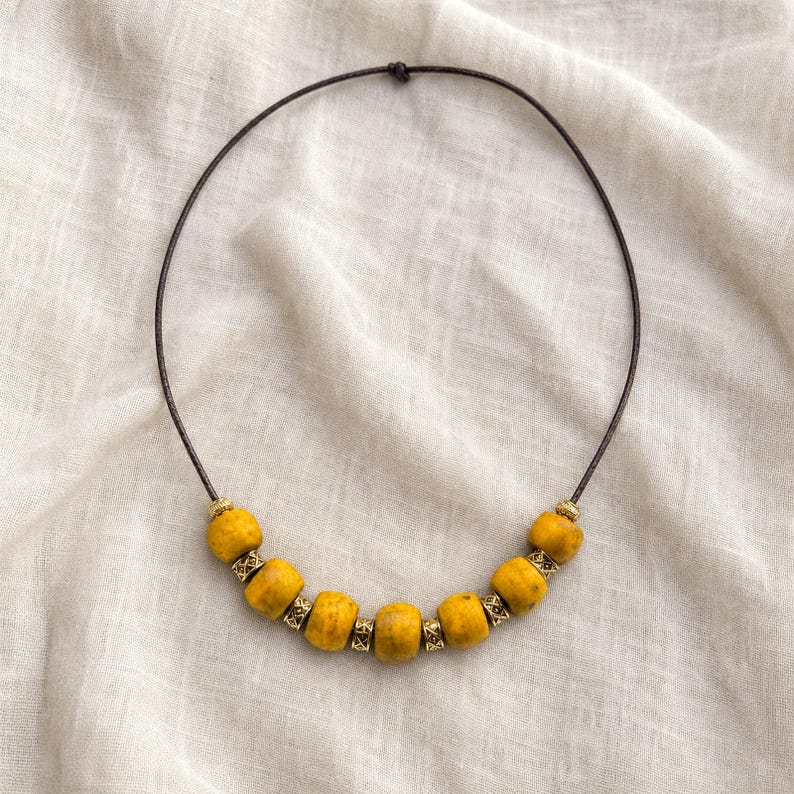 Mustard Yellow Beaded Necklace presented in an open jewelry gift box on natural linen