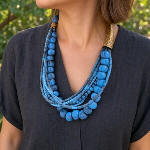 Three-piece handmade necklace set featuring rose gold and blue beaded necklace, beige and rose gold beaded necklace and rose gold and gray beaded necklace, displayed together to show the coordinated colors and beadwork