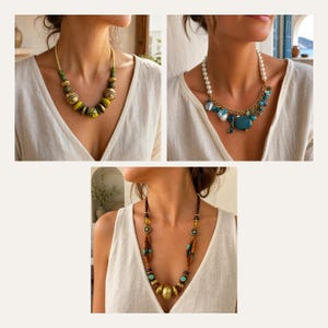 May include: A collection of three necklaces featuring diverse designs. One necklace has green and gold-toned beads, another displays white pearls with blue charms, and the third features brown wooden beads with turquoise accents and a central gold-toned pendant.