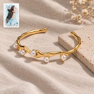 Gold Tone Cuff Bracelet, laid on fabric. A sample personalized digital greeting card is shown alongside.
