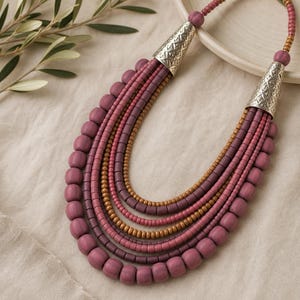 Rose Gold and Brown Statement Beaded Necklace presented in an open jewelry gift box on natural linen