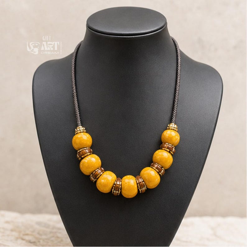 Main product photo of mustard yellow beaded boho statement necklace displayed in a clean Etsy studio composition