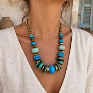 Rose Gold and Brown Statement Beaded Necklace presented in an open jewelry gift box on natural linen