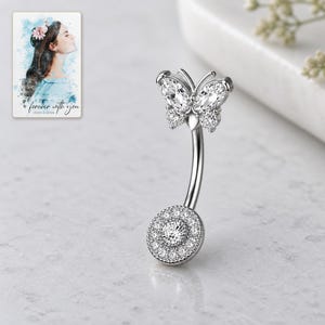 Close view of the four-stone style butterfly, curved silver-tone shaft and round pavé disc. A personalized digital greeting card is shown alongside.
