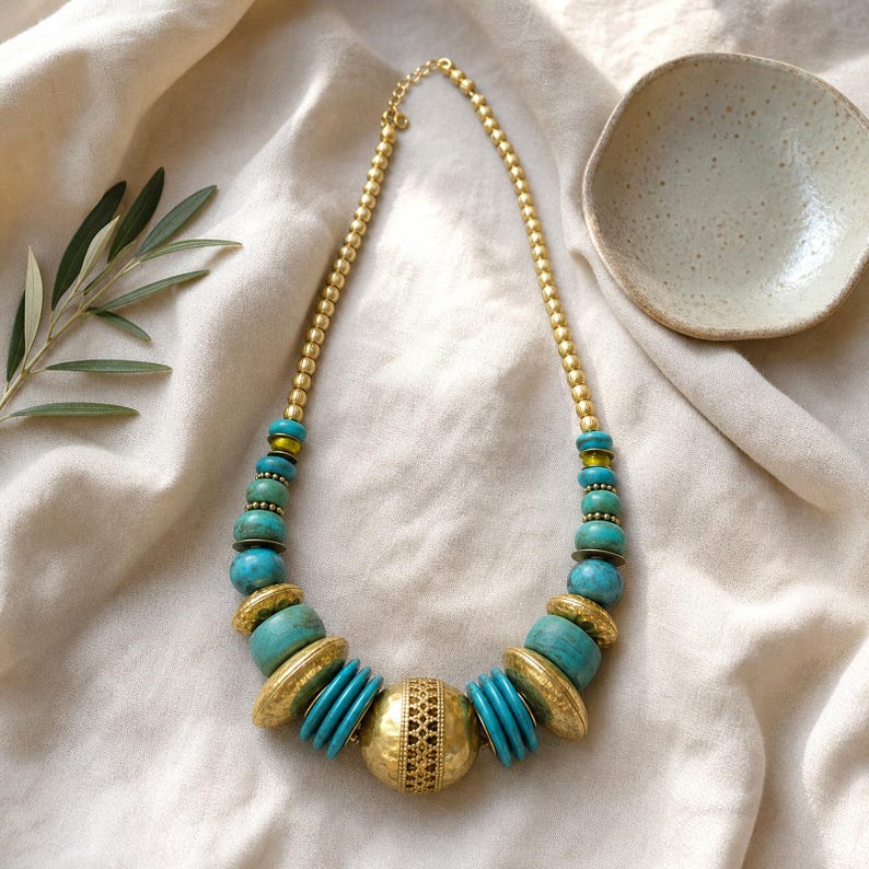 Gray and Rose Gold Statement Beaded Necklace presented in an open jewelry gift box on natural linen