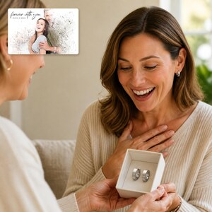 May include: A rectangular card featuring a stylized photo of a couple with the text "forever with you" and "OLIVIA & ADAM" above a small white gift box containing two silver-toned metal rings with a smooth, polished finish and a simple band design.